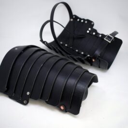 A pair of Shoulder Armor Style 4 sitting on top of a white table.