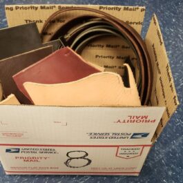 a cardboard box filled with different types of belts.