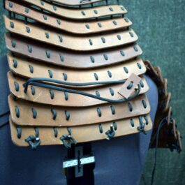 a close up of a mannequin's torso with leather pieces on it.