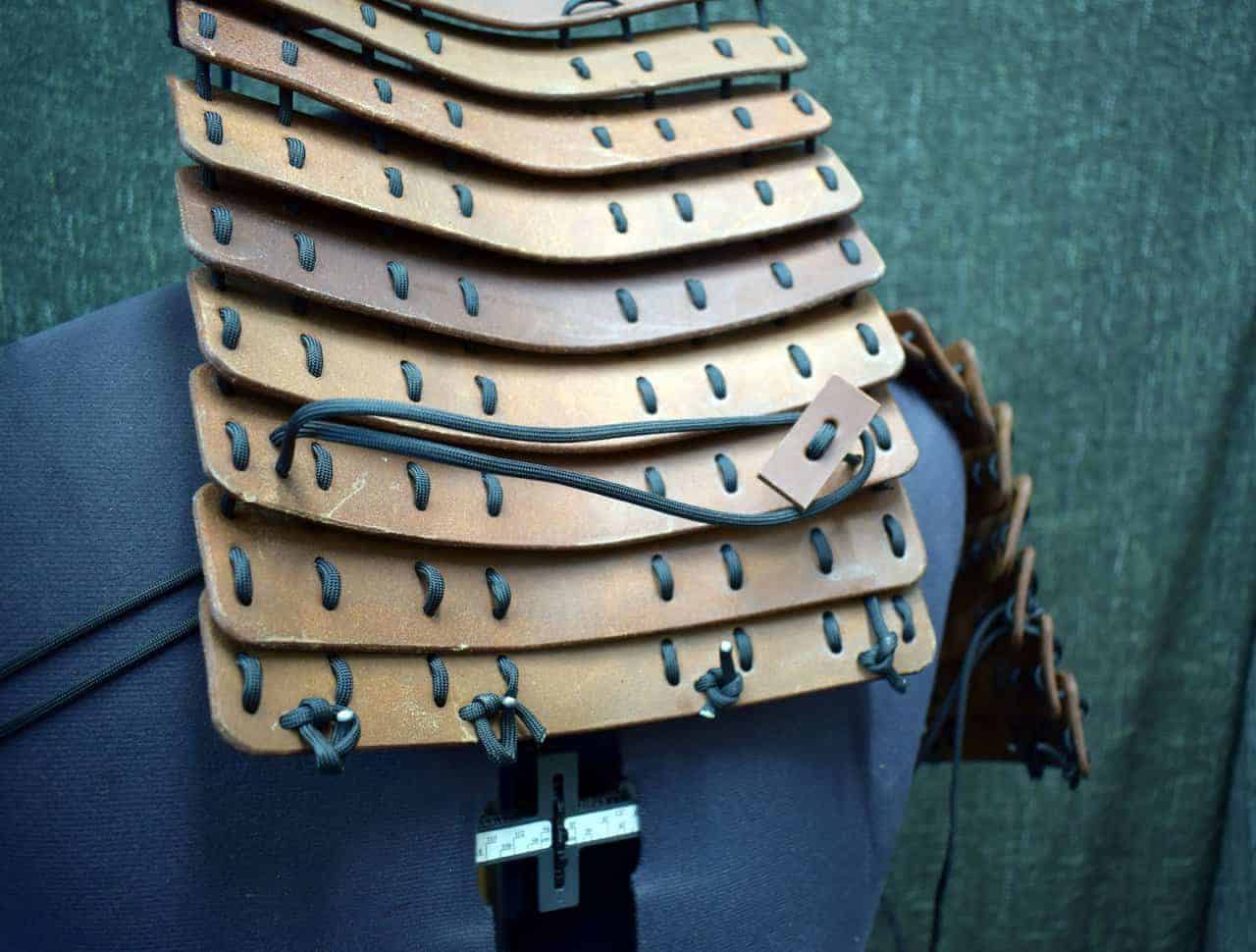 a close up of a mannequin's torso with leather pieces on it.