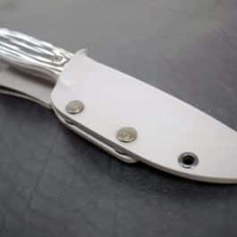a knife with a Kydex sheath for the Benchmade Saddle Mountain Hunter on a table.