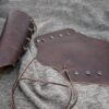 a brown Soft Leather Mirkwood Vambraces laid on a cloth - renaissance clothing - renaissance clothing men - renaissance clothing women - renaissance clothing near me - renaissance costume ideas - sword baldrics - baldrics leather - baldric belt