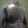 a black leather jacket with a hood on a mannequin.