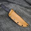 a knife is laying on a gray cloth.