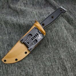 a knife that is laying on a piece of cloth.