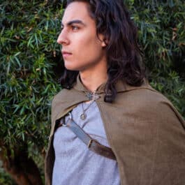 A young man dressed in a Linen Hooded Cloak.