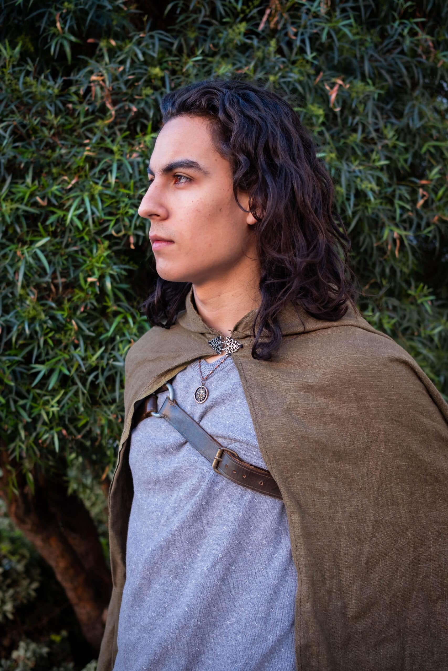 A young man dressed in a Linen Hooded Cloak.