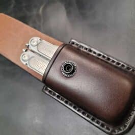 A close up of a Molded Leather Multi Tool pouch on a table.