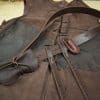a brown leather vest with a brown bow tie.