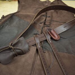 a brown leather vest with a brown bow tie.