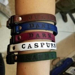 a woman's arm with a Leather Cat Collar on it.