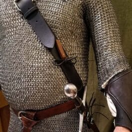 A man wearing a Ranger Baldric holding a pair of scissors.