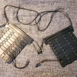 a Samurai Style Shoulder Armor sitting on top of a bed.