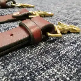 a pair of Lumberjack Suspenders laying on a carpet.
