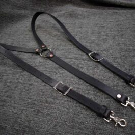 A pair of Lumberjack Suspenders on a gray cloth.