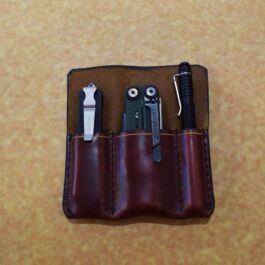 A Handmade Leather 3 Slot Pocket Organizer with a pair of scissors and a pair of pliers in it.