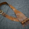brown Bison Leather Baldric laid on a cloth - renaissance clothing - renaissance clothing men - renaissance clothing women - renaissance clothing near me - renaissance costume ideas - sword baldrics - baldrics leather - baldric belt