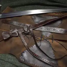 a Strider Belt sitting on top of a piece of leather.