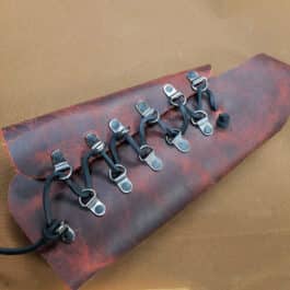 An Archers Vambrace with a bunch of keys attached to it.