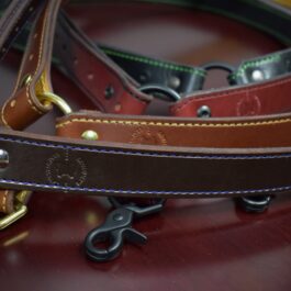 Four leather single point sling laid on a wooden table - Grommet's Leathercraft - renaissance clothing - renaissance art clothing - renaissance era clothing - leathercraft supplies - leathercraft accessories - leathercraft store near me - quality leather craft