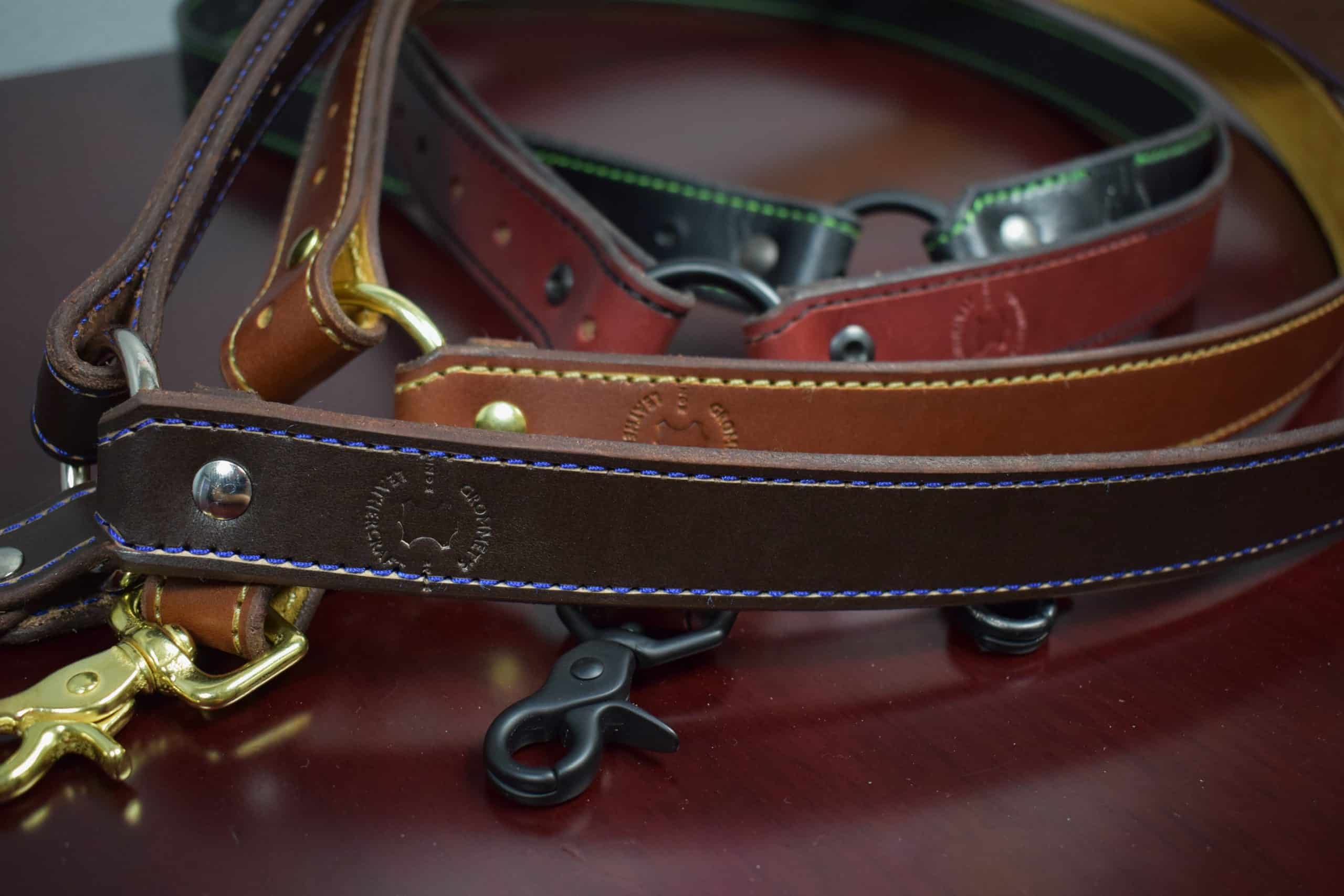 Four leather single point sling laid on a wooden table - Grommet's Leathercraft - renaissance clothing - renaissance art clothing - renaissance era clothing - leathercraft supplies - leathercraft accessories - leathercraft store near me - quality leather craft