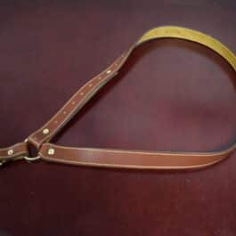 One brown leather single point sling laid on a wooden table - Grommet's Leathercraft - renaissance clothing - renaissance art clothing - renaissance era clothing - leathercraft supplies - leathercraft accessories - leathercraft store near me - quality leather craft