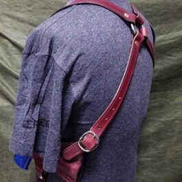 the back of a woman's dress with a Shoulder Holster For Full Size 1911 leather shoulder strap.