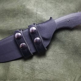 a Kydex sheath for the Benchmade Fixed Contego on a green cloth.