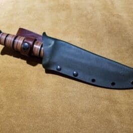 a Kydex Sheath for the Ka Bar Fighting Knife sitting on a table.