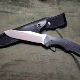 A Leather Sheath for the Benchmade Fixed Contego that is laying on a cloth.