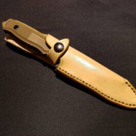 A Benchmade Nimravus/Protagonist knife with a Handmade Leather Sheath on a black surface.