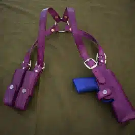 a leather shoulder holster for the Beretta Px4 Storm on a bed.