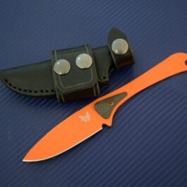 A Benchmade Altitude knife with a handmade leather sheath on a blue surface.