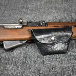 An Leather SKS Stripper Clip Belt Pouch sitting on a couch.