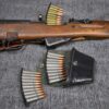 A Leather SKS Stripper Clip Belt Pouch and other items are laying on the floor.