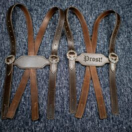 A pair of Handmade Leather Lederhosen Suspenders with a name on them.