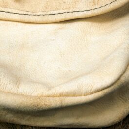 A close up of a dog's fur with a Brain Tan Frontiersman Saddlebag on top of it.