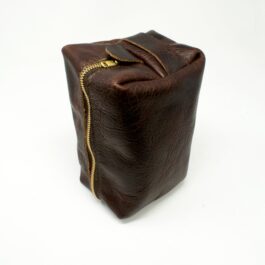 A brown Leather Dopp Kit/Toiletry Bag with a gold zipper.