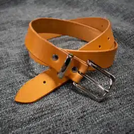 A handmade leather dress belt with a metal buckle.