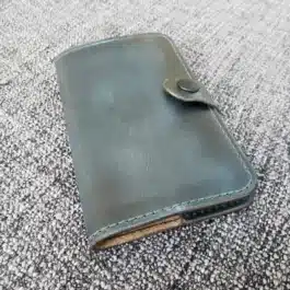 green Leather Field Notes Cover laid on a cloth - renaissance clothing - renaissance clothing men - renaissance clothing women - renaissance clothing near me - renaissance art clothing - renaissance era clothing - renaissance costume ideas