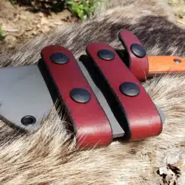 A Kydex Sheath for the Benchmade Nestucca Cleaver sitting on top of a rock.