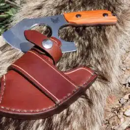 A Leather Scout Sheath for the Benchmade Nestucca Cleaver on a rock.