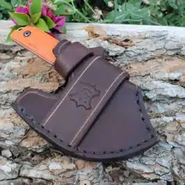 A brown Leather Scout Sheath for the Benchmade Nestucca Cleaver with a flower on top of it.