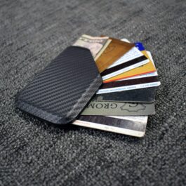 a pile of Kydex Wallets laying on top of each other.