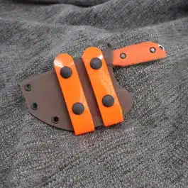 a Kydex sheath for the Benchmade Nestucca Cleaver sitting on top of a gray cloth.