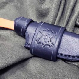 The Handmade Leather Sheath for the Benchmade Altitude knife laying on a cloth.
