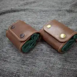 A Waxed Canvas Bushcraft Foraging/Dump Pouch sitting on top of a bed.