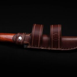 A handmade leather sheath for the Buck 105 with a wooden handle on a black background.