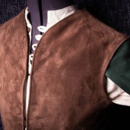 A Suede Elven Jerkin with a green and white collar.