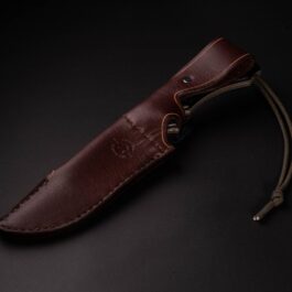 a Handmade Leather Sheath for the TOPs Longhorn Bowie on a black surface.